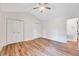 Bedroom boasts hardwood floors, a ceiling fan, and dual closets, offering ample storage at 500 W Woodcroft Pkwy, Durham, NC 27713