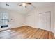 Bedroom featuring hardwood floors, ceiling fan and access to a porch at 500 W Woodcroft Pkwy, Durham, NC 27713