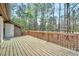 Wooden deck offers a serene outdoor space with mature trees in the background at 500 W Woodcroft Pkwy, Durham, NC 27713
