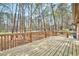 Spacious wooden deck surrounded by lush trees, perfect for outdoor enjoyment and relaxation at 500 W Woodcroft Pkwy, Durham, NC 27713