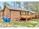 Home exterior with a wooden deck, brick facade, and well-kept landscaping at 500 W Woodcroft Pkwy, Durham, NC 27713