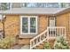 Brick exterior with steps and white painted railings to the front door at 500 W Woodcroft Pkwy, Durham, NC 27713