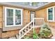 Brick exterior with steps and white painted railings to the front door at 500 W Woodcroft Pkwy, Durham, NC 27713