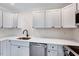Modern kitchen features white cabinets, stainless steel appliances, and sleek countertops at 500 W Woodcroft Pkwy, Durham, NC 27713