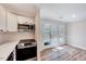 Bright kitchen with stainless steel appliances and access to the outdoor deck at 500 W Woodcroft Pkwy, Durham, NC 27713