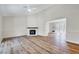 Bright living room with vaulted ceiling, wood floors, and fireplace at 500 W Woodcroft Pkwy, Durham, NC 27713