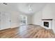 Bright living room with vaulted ceiling, wood floors, and fireplace at 500 W Woodcroft Pkwy, Durham, NC 27713