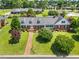 Aerial view of a beautifully landscaped home with a brick walkway and lush greenery at 504 W Brocklyn St, Benson, NC 27504