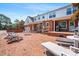 Expansive brick patio with outdoor seating and string lights, perfect for entertaining in the beautiful backyard at 504 W Brocklyn St, Benson, NC 27504