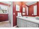 Classic bathroom with vanity, framed mirror, and shower with textured wallpaper at 504 W Brocklyn St, Benson, NC 27504