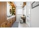Bathroom featuring double sinks, vanity, unique lighting, and ample cabinet space at 504 W Brocklyn St, Benson, NC 27504