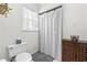 Bathroom featuring toilet, vanity, and decorative curtain at 504 W Brocklyn St, Benson, NC 27504