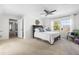 Bright bedroom featuring neutral walls, plush carpet, and a ceiling fan at 504 W Brocklyn St, Benson, NC 27504