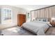 Bright bedroom with a comfortable bed, large windows, and neutral decor at 504 W Brocklyn St, Benson, NC 27504
