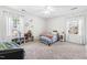 Bright bedroom featuring neutral walls, plush carpet, and two windows at 504 W Brocklyn St, Benson, NC 27504