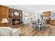 Open-concept dining area with brick fireplace, wood floors, and modern decor at 504 W Brocklyn St, Benson, NC 27504