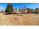 Charming two-story brick home with dormer windows, mature trees, and a well-manicured lawn at 504 W Brocklyn St, Benson, NC 27504
