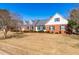 Charming one-story brick home with a manicured lawn and beautiful landscaping at 504 W Brocklyn St, Benson, NC 27504