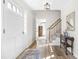 Inviting foyer with hardwood floors, staircase and a light, neutral color palette at 504 W Brocklyn St, Benson, NC 27504
