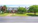Quaint brick home featuring a lush front lawn, flowering trees, and inviting curb appeal at 504 W Brocklyn St, Benson, NC 27504