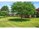 Charming brick home with a lush front yard and mature trees offering shade and curb appeal at 504 W Brocklyn St, Benson, NC 27504