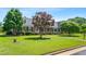 Beautiful brick home with lush green lawn and mature trees at 504 W Brocklyn St, Benson, NC 27504