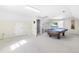 Spacious game room featuring a pool table, built-in shelving, and carpet flooring for cozy entertainment at 504 W Brocklyn St, Benson, NC 27504