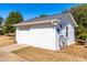 A white detached garage with decorative elements and ample storage space at 504 W Brocklyn St, Benson, NC 27504