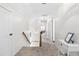 Bright hallway featuring carpeted floors, white walls, and a staircase leading to the upper level at 504 W Brocklyn St, Benson, NC 27504
