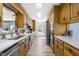 Well-lit kitchen offers stainless steel appliances, white countertops, and wood cabinets with ample storage at 504 W Brocklyn St, Benson, NC 27504