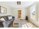 Cozy living room featuring a comfortable couch, rustic coffee table, and warm natural light at 504 W Brocklyn St, Benson, NC 27504