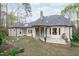 Expansive backyard featuring a stone patio, well-manicured lawn, and mature landscaping at 506 Rose Point Dr, Cary, NC 27518