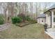 Side view of landscaped backyard featuring a garden and stone-lined walkway at 506 Rose Point Dr, Cary, NC 27518