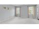 Light-filled bedroom with plush carpet, light blue walls, and two large windows with curtains at 506 Rose Point Dr, Cary, NC 27518
