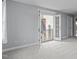 Large bedroom features neutral carpet, fresh paint, and access to an outdoor balcony at 506 Rose Point Dr, Cary, NC 27518