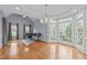 Bright dining room featuring hardwood floors, large windows, and a chandelier at 506 Rose Point Dr, Cary, NC 27518