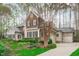 Charming home showcasing a well-maintained lawn, stone detailing, and an attached two-car garage at 506 Rose Point Dr, Cary, NC 27518