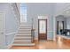 Grand foyer with a staircase, beautiful hardwood floors, and a decorative front door at 506 Rose Point Dr, Cary, NC 27518