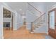 Spacious foyer with staircase, hardwood floors, and access to multiple rooms creating an open layout at 506 Rose Point Dr, Cary, NC 27518