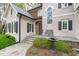 Inviting front entrance with a stone walkway, complemented by stylish windows and a bench seating area at 506 Rose Point Dr, Cary, NC 27518