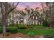 Stately two-story home featuring lush landscaping, stone accents, and a welcoming front entrance at 506 Rose Point Dr, Cary, NC 27518
