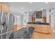 Large kitchen with stainless steel appliances, granite counters, island, and view to the backyard at 506 Rose Point Dr, Cary, NC 27518