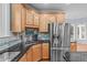 Close up of kitchen area features stainless appliances, granite counters, and custom cabinets at 506 Rose Point Dr, Cary, NC 27518