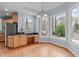 Bright eat-in kitchen with custom cabinets, granite counters, and large windows overlooking the backyard at 506 Rose Point Dr, Cary, NC 27518
