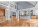 Open-concept living area with hardwood floors, tall ceilings, and seamless flow to the kitchen and dining areas at 506 Rose Point Dr, Cary, NC 27518