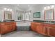 Luxurious bathroom with a corner bathtub, tile surround, double sinks, and updated fixtures at 506 Rose Point Dr, Cary, NC 27518