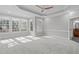 Spacious main bedroom with tray ceilings, recessed lighting, plush carpet, and large windows at 506 Rose Point Dr, Cary, NC 27518