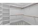 White walk-in closet with shelving on the side and rods for hanging clothes at 506 Rose Point Dr, Cary, NC 27518