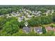 Aerial view of a home in a neighborhood covered by lush green trees at 5144 Pinehall Wynd, Raleigh, NC 27604