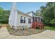 Home's back exterior featuring screened porch, patio, and well-maintained yard at 5144 Pinehall Wynd, Raleigh, NC 27604